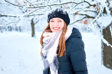 Beautiful Girl playing with snow in park