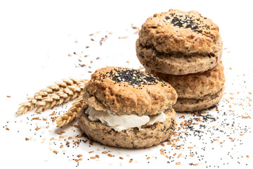 Wholemeal seeded scones stuffed with cream isolated on white