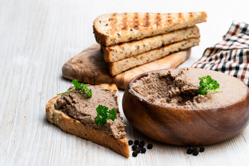 Fresh pate with toasted bread on white table