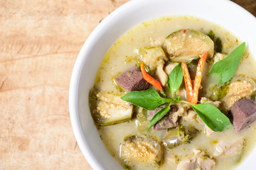 Thai green curry chicken (Kang Keaw Wan Kai) in a bowl on wooden, Thai food