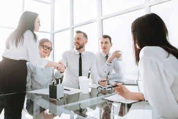 welcome handshake employees near the desktop in the office