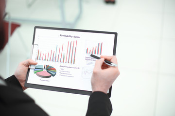 rear view.the businessman checks the financial report.photo with copy space