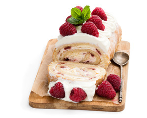 Homemade swiss roll cake with raspberry isolated on white