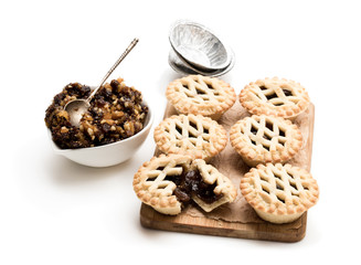 Mince pie served on the wooden board isolated on white