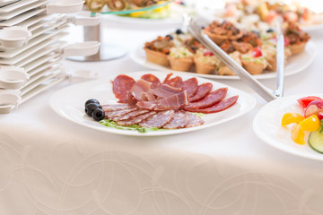 slices of salami and meat on the festival table