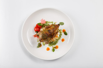 Food on white plate. Meat. Rosemary greens. A tomato. Mushrooms.