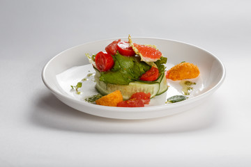 Food on white plate. Side dish. Greenery. Fruits. Vegetables.