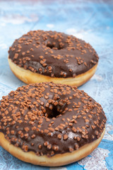 Donut Filled With Chocolate Topping On The Blue Background