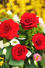 Beautiful festive bouquet close-up. Bright bouquet with red roses as a gift. 