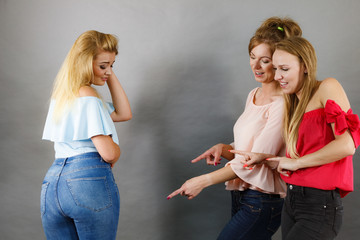 Women gossiping about friend body shape