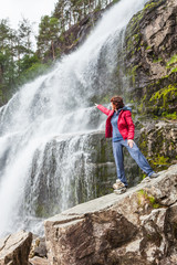 Tourist woman at waterfall Svandalsfossen, Norway