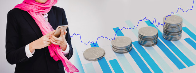 Arab businesswoman with stack of money coins and growth graph