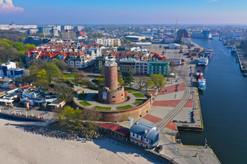 Aerial view on Kolobrzeg city, area of Lighthouse at baltic sea shore and ship port.