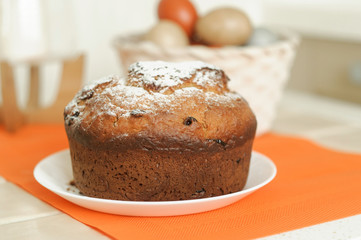 Freshly baked Easter cake and colored eggs, selective focus.