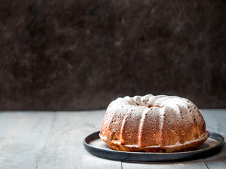 Fresh perfect muffin cake decorated icing sugar over table. Copy space for text. Ideas and recipes...