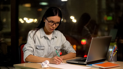 Fototapeta premium Female designer drawing sketches looking laptop, educational online lesson