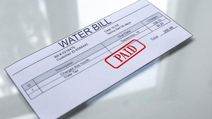 Paid seal on water bill, payment for services, month expenses, tariff close up