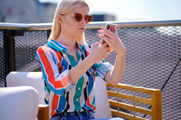the girl is taking a picture of herself on the roof of a building in the city