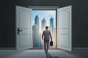 Fototapeta premium Businessman entering big large door
