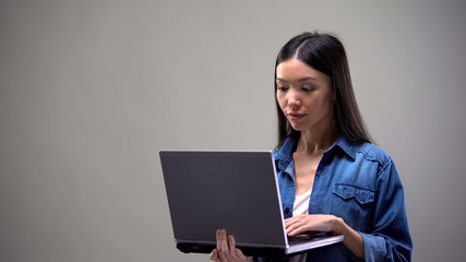 Concentrated freelancer working on computer, job for students, remote work