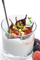 Homemade yogurt with grilled figs and pistachio isolated on white