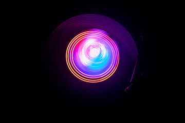 Concept of speed - Trail of fire and smoke - Vinyl record. Burning vinyl disk. Turntable vinyl record player. Retro audio equipment for disc jockey. Sound technology