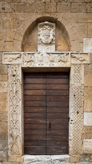 The carved stone entrance of an ancient Italian medieval church.