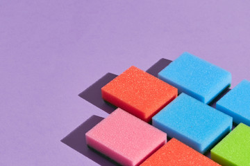 Colorful sponges isolated on blue background.close up photo. copy space.