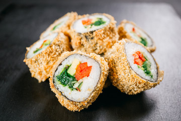 sushi, japanese food, deluxe restaurant menu, delicious traditional seafood. philadelphia and vegetarian tempura sushi rolls, served on black plate