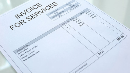 Naklejka na ściany i meble Invoice for services commercial document lying on table, business, template