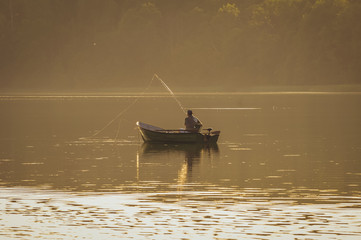 Small fishing boat on a Lanskie Lake in Olsztyn Lake District, near Lansk village in Warmian-Masurian Voivodeship, Poland