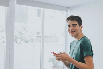 young or teen at home with mobile phone