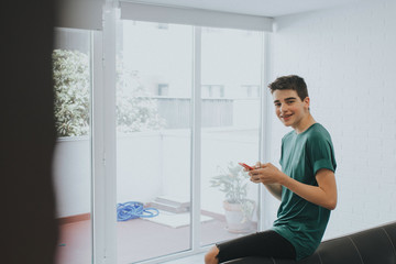 young or teen at home with mobile phone