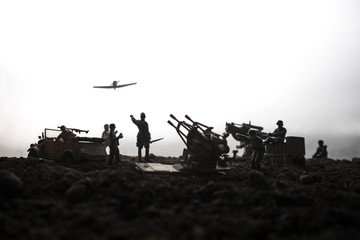 An anti-aircraft cannon and Military silhouettes fighting scene on war fog sky background. Allied...