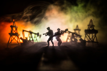 Silhouette of military soldier or officer with weapons. shot, holding gun, colorful sky,...