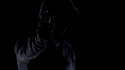 Cruel killer in black clothes aiming gun at camera, contract murder, shooting