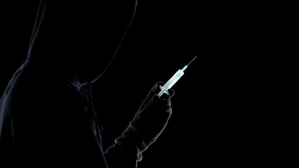 Criminal silhouette holding syringe with toxic acid, preparing to kill enemy