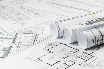 Architectural construction drawings twisted into a roll, construction projects on paper. The...
