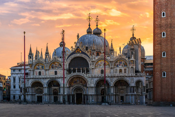 Fototapeta na wymiar Fantastic sunset on San Marco square with Campanile and Saint Mark's Basilica. Colorful evening cityscape of Venice, Italy, Europe. Traveling concept background. Artistic style post processed photo.