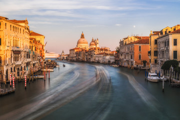 Classic panoramic view of famous Canal Grande with scenic Basilica di Santa Maria della Salute in beautiful golden evening light at sunset with retro vintage filter effect, Venice, Italy