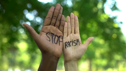Interracial people hands with stop racism phrase, fight against discrimination