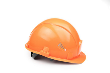 Orange construction helmet on a light background. The concept of architecture, construction, engineering, design. Copy space.
