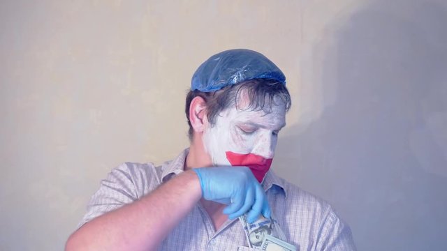 excerpt from the short speech of the funny actor men mime.actor performs with a stack of hundred dollar bills.pantomime.