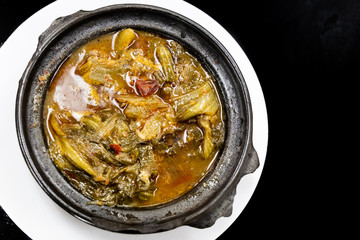 Traditional Chinese sour spicy mustard vegetable delicacy in claypot