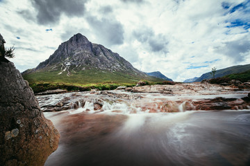 Beautiful river mountain landscape scenery in Glen Coe, Scottish Highlands, Scotland