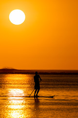 Stand up Paddling at sunset in Le Morne in Mauritius, Africa.