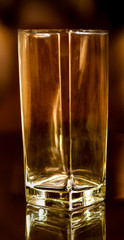 Empty glass on a golden backround