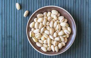 Healthy food  for background image close up pistachios nuts. Texture on top view Nuts pistachio on the cup plate