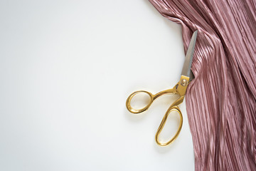 top view image of tailoring scissors with pink fabric