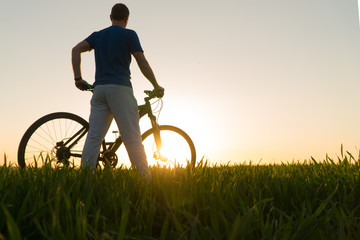 Fototapeta premium man on bike. sunset bike. bike at sunset.